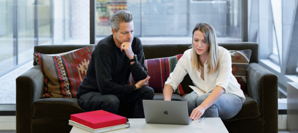 Couple reviewing a shared budget on their laptop