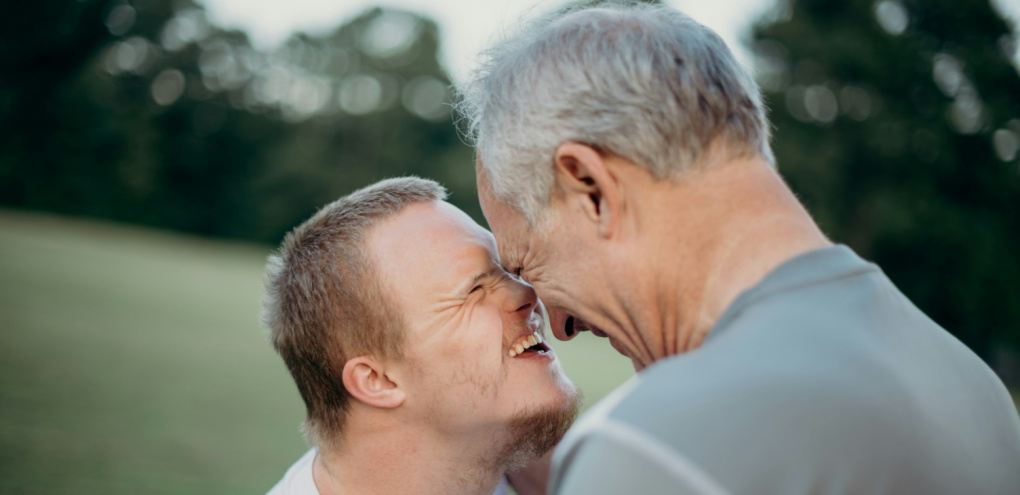 Father embracing his son with special needs