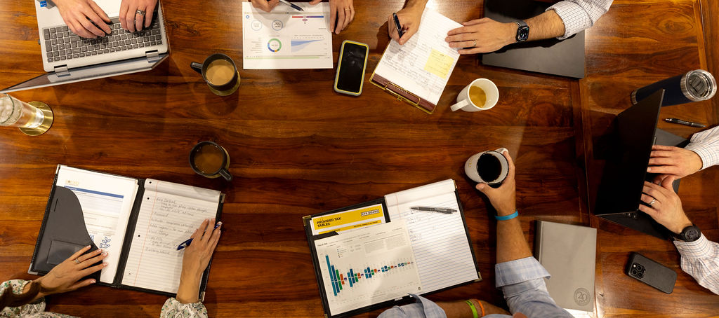 An image of a group of financial planners reviewing reports