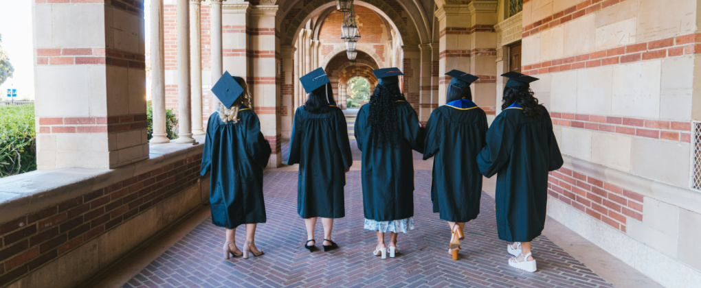 Picture of a group of graduates walking down a university campus