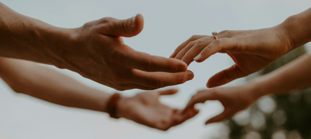 Image of hands reaching out and connecting for charitable causes.