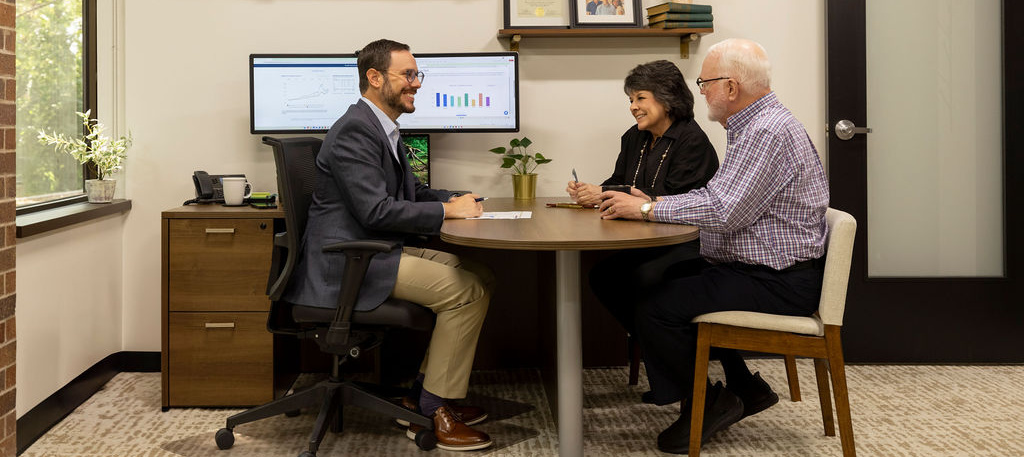 Image of fiduciary financial advisor meeting with a couple approaching retirement.