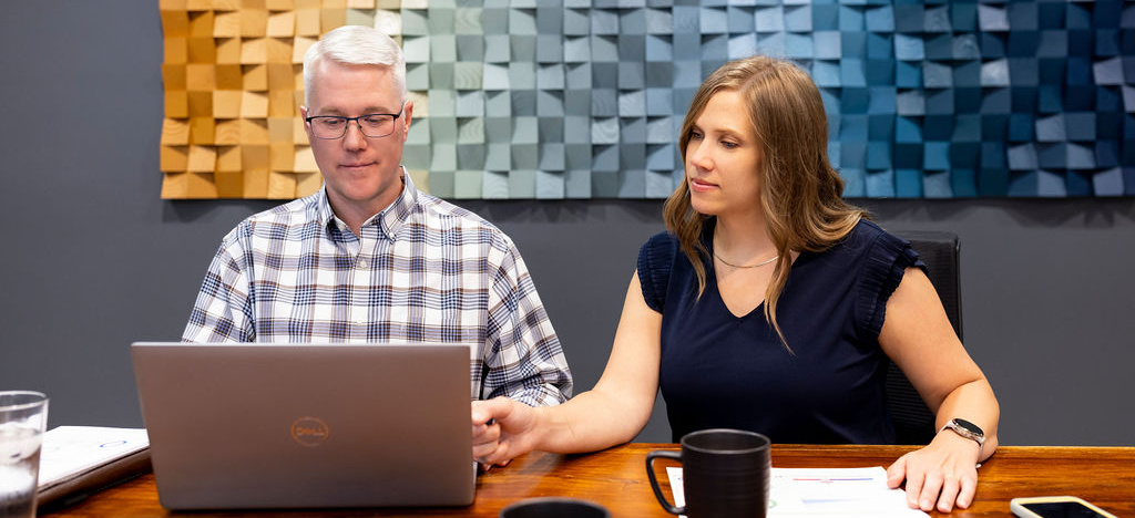 Image of an advisor guiding a client through uploading documents.